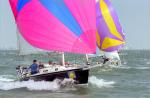 ID 4726 COWES WEEK 1996 - a stiff breeze fills the colourful spinnakers off the Cowes waterfront, Isle of Wight, UK during the week-long regatta.